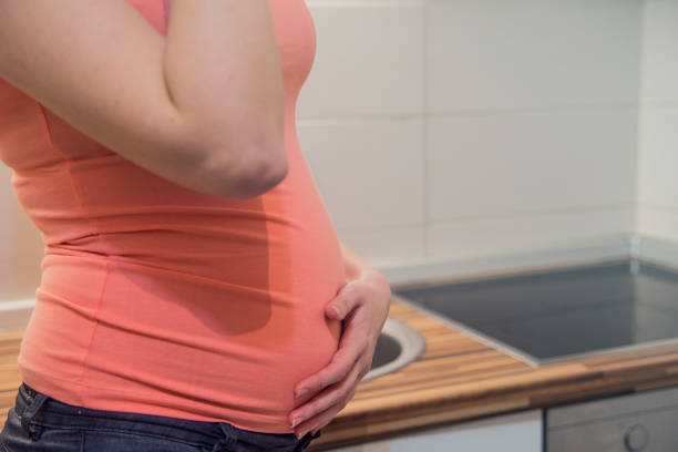 istock Future mom expecting baby drinking natural water indoors. 653007928