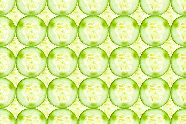 istock Close up of fresh cucumber slices background 653008550