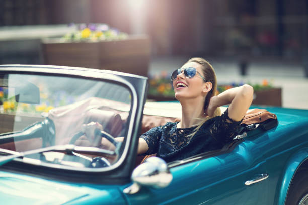 modelo de mujer de moda en gafas de sol sentado en coche retro de lujo - luxury car fotografías e imágenes de stock