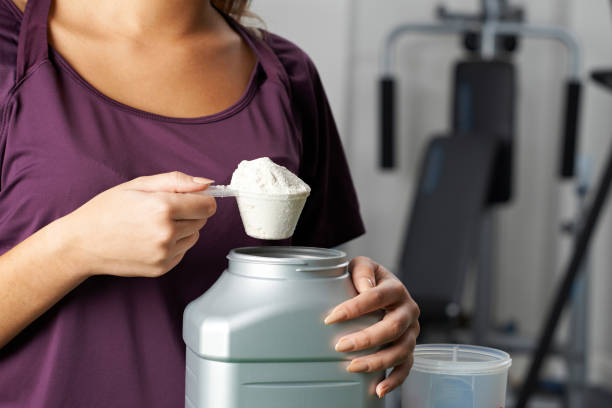 istock Young Woman In Gym Taking Nutritional Supplement 653013846