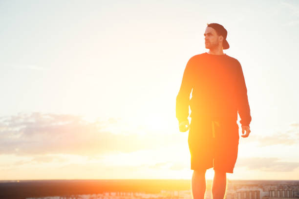 istock Risky man standing on the top of the roof 653014404