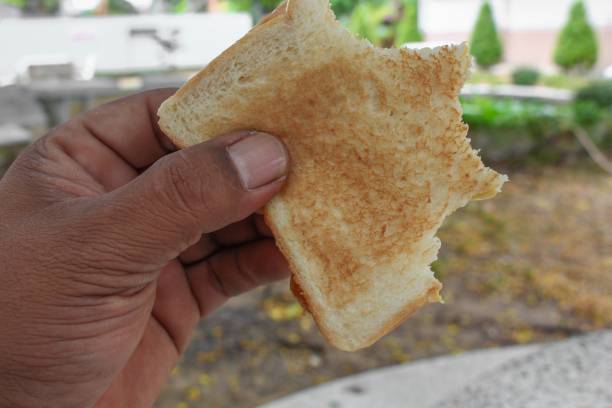istock Bread slices and jam in hand Close up 653018704