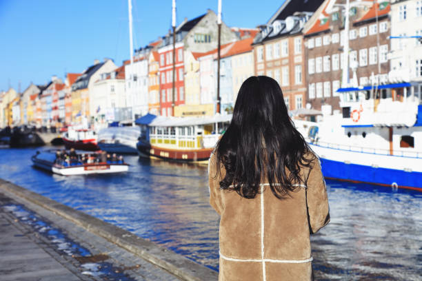 Woman watching Nyhavn, Copenhagen, Denmark. - February 15, 2017