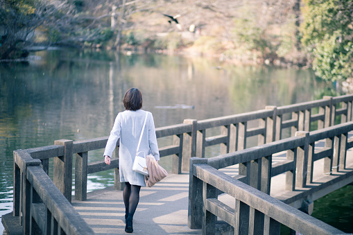 Young woman crossing bridge