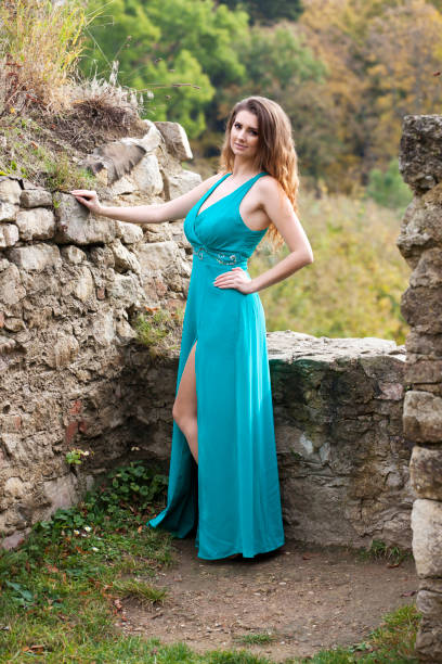 istock Beautiful woman near a stone wall 653035650