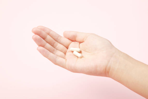 istock White capsule with the Palm of your hand 653039626
