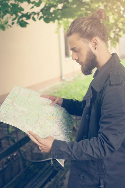 istock Tourist looking for places on a map. 653040332