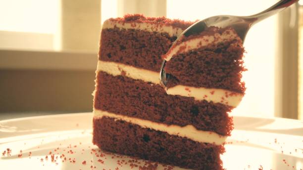 istock Taking piece of biscuit cake with a tea spoon 653047486