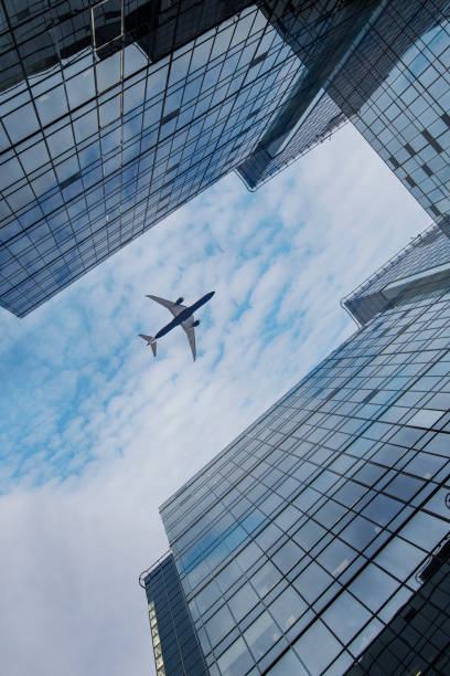 istock Airplane flying over business area. 653050110