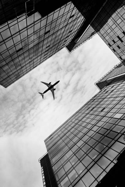 istock Airplane flying over business area. 653050928