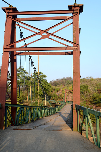 A iron hanging bridge on a river in Assam,India