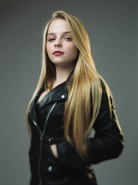 Young fashion blonde business woman on city street Stylish female model in dark blue jacket and white shirt