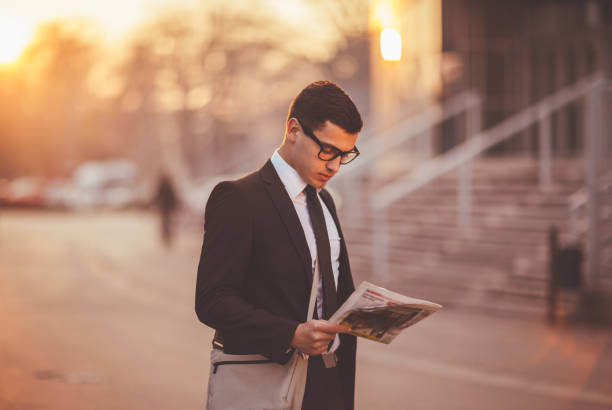 istock Businessman reading newspaper 653055620