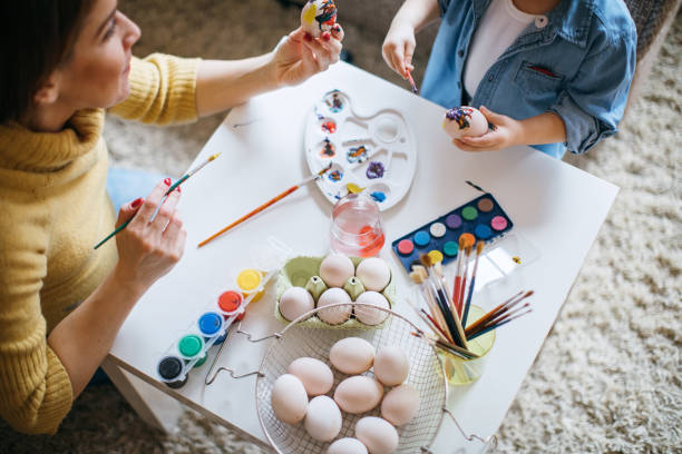 istock Mother and Her Little Boy Painting Easter Eggs 653055678
