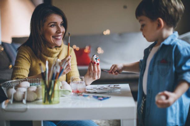 istock Mother Helps her Boy To Color Eggs 653055752