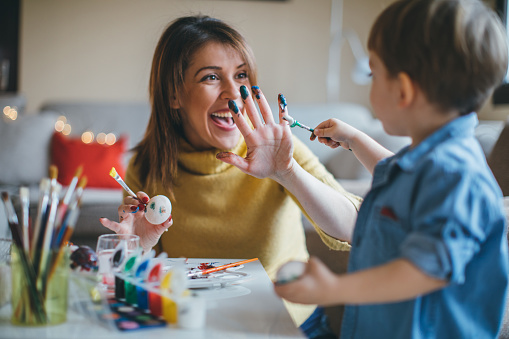 Easter day, Mother and her son preparing for Easter, painting Easter eggs