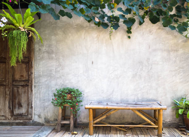 istock bamboo bench with decorative plant on concrete wall background 653061804