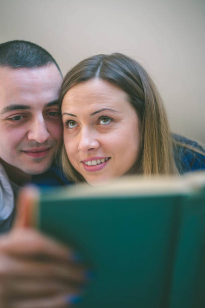 istock Happy couple relaxing together on their bed 653062458