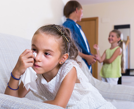 First amorousness: offended spanish girl and couple of kids apart indoors