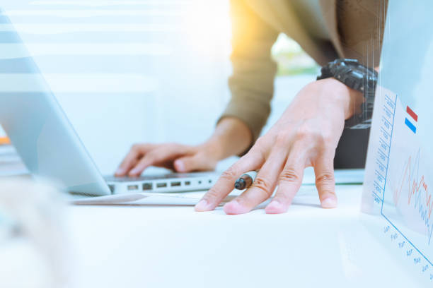 istock business documents on office table and graph business diagram and business people working in the background,business content,business background. 653068994