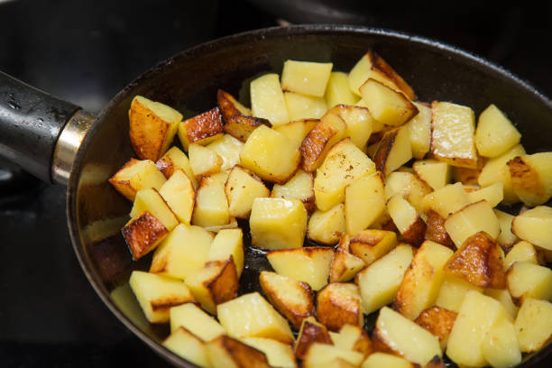 Fresh potatoes fried in a pan with butter close up.