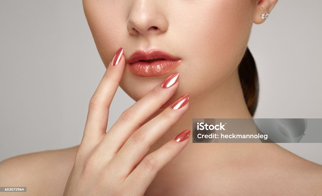 Beauty brunette woman with perfect makeup Beauty brunette woman with perfect makeup. Glamour girl. Red lips and nails. Skin care foundation. Beauty girls face isolated on light background. Fashion photo Fingernail Stock Photo