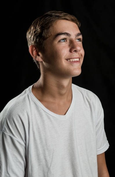 Friendly Teenager Smiling With White T Shirt Stock Photo - Download Image Now - Profile View, Teenager, Looking Up - iStock Friendly Teenager Smiling With White T Shirt Stock Photo - Download Image Now - Profile View, Teenager, Looking Up - iStock