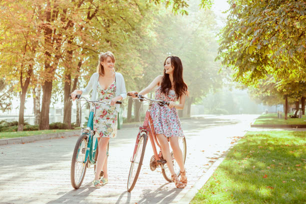 istock The two young girls with bicycles in park 653076544