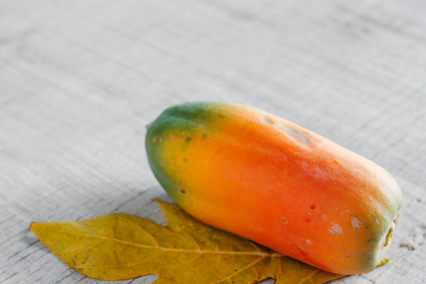 istock papaya on wooden floor. 653076808