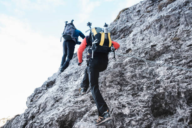 istock Hikers climb mountain on equipped trail 653077030