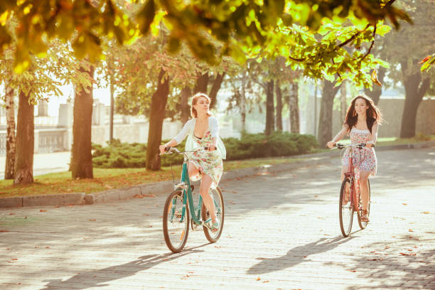 istock The two young girls with bicycles in park 653077132