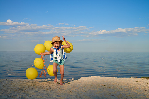 Happy little girl having fun on the beach