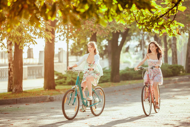 istock The two young girls with bicycles in park 653077304
