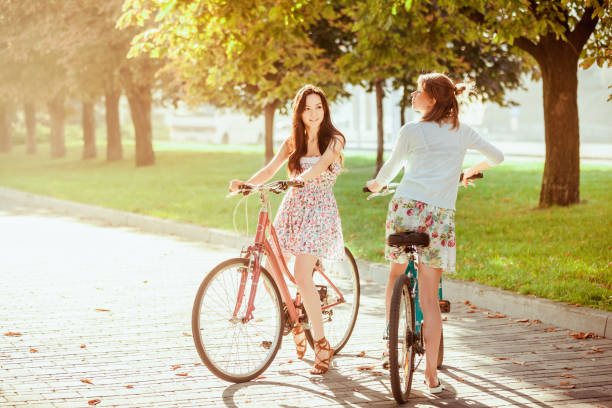 istock The two young girls with bicycles in park 653077640
