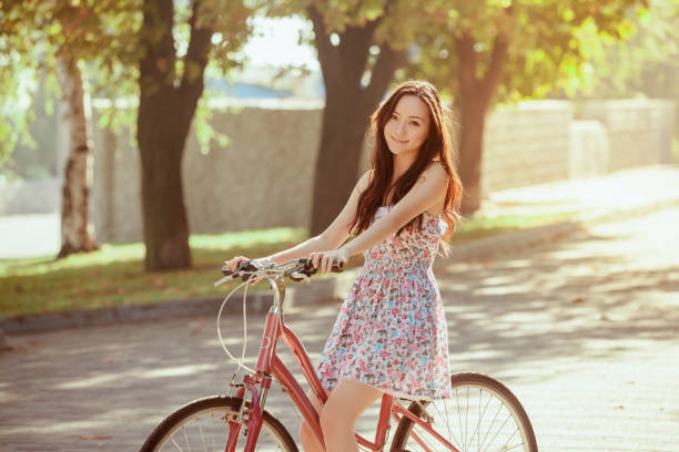 istock The young girl with bicycle in park 653080116