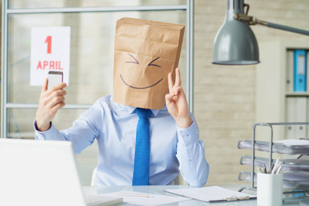 Making selfie Businessman in paper bag making selfie at office april fools day stock pictures, royalty-free photos & images