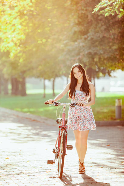 istock The young girl with bicycle in park 653080484