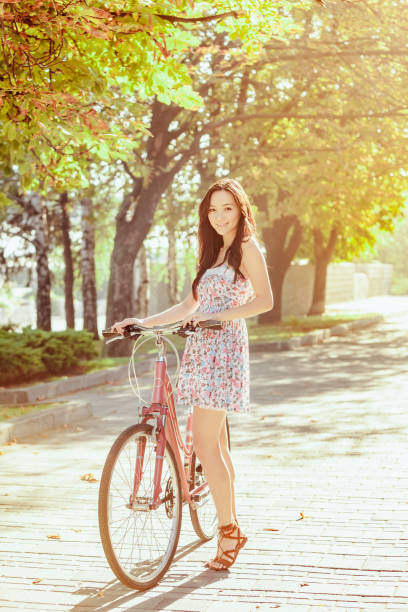 istock The young girl with bicycle in park 653080856