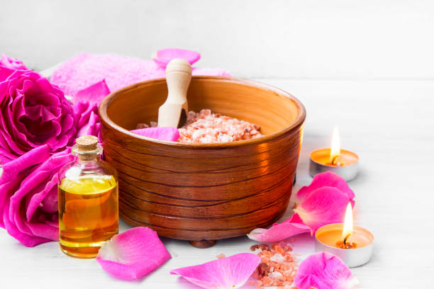 istock Roses spa setting with bath salt, roses flowers, bath rose oil, still life set 653084964