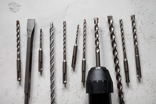 Close up of drill bits on concrete background. This file is cleaned and retouched.