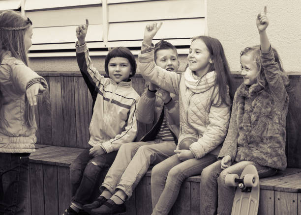 istock Group of ordinary children playing charades 653090832