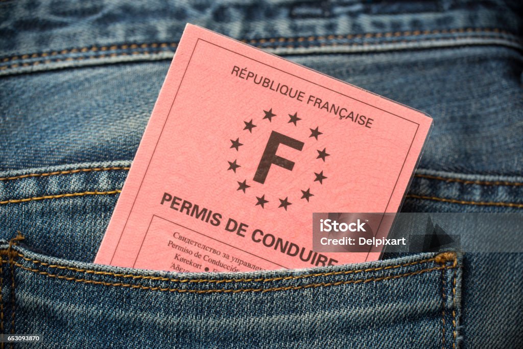 French driving license in the rear pocket of blue jeans, driving licence test concept Driver's License Stock Photo