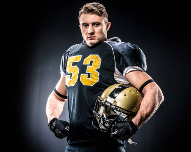 istock American football player holding helmet 653101806