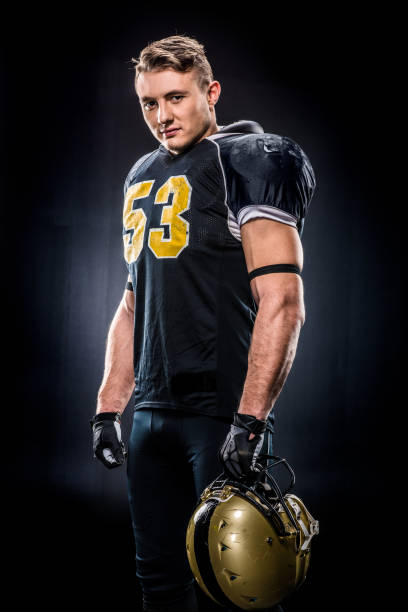 istock American football player holding helmet 653101828