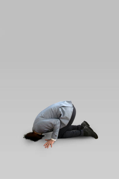 istock Business man looking through a ground hole. 653111806