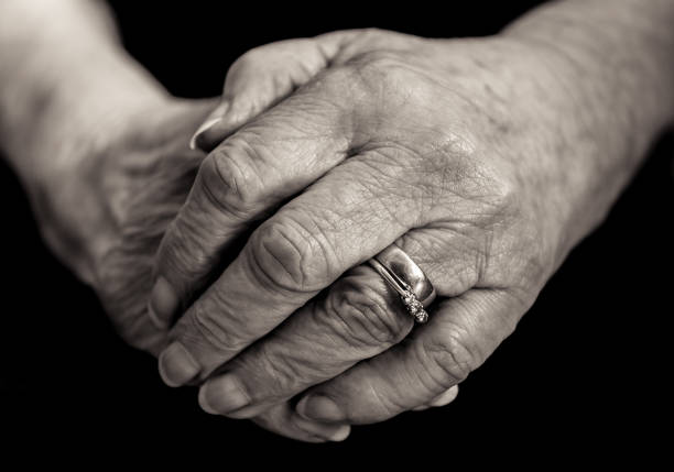 istock Monochrome close up of an elderly married lady's hands. 653112654