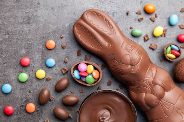 Chocolate Easter bunny and eggs on rustic background Delicious chocolate Easter bunny, eggs and sweets on rustic backgroundDelicious chocolate Easter bunny and eggs on rustic background chocolate bunny stock pictures, royalty-free photos & images