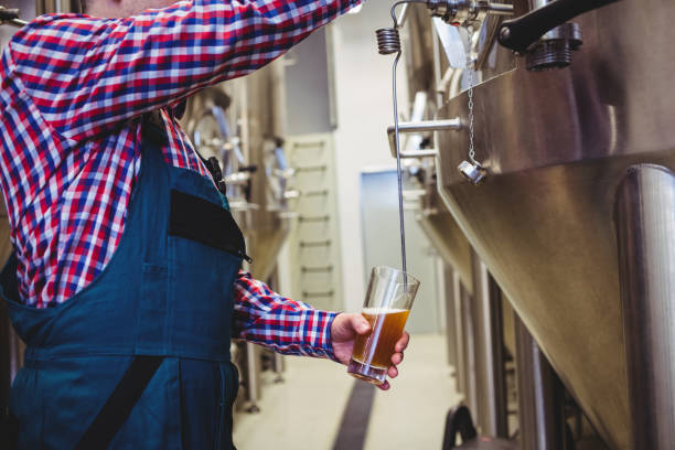 istock Manufacturer filling beer from storage tank 653117300
