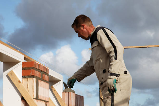 istock stonemason bricklayer puts mortar on a wall outdoors 653123816