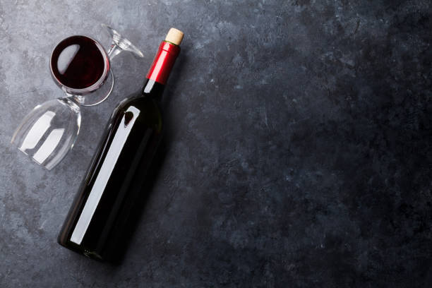 istock Red wine glasses and bottle 653123828